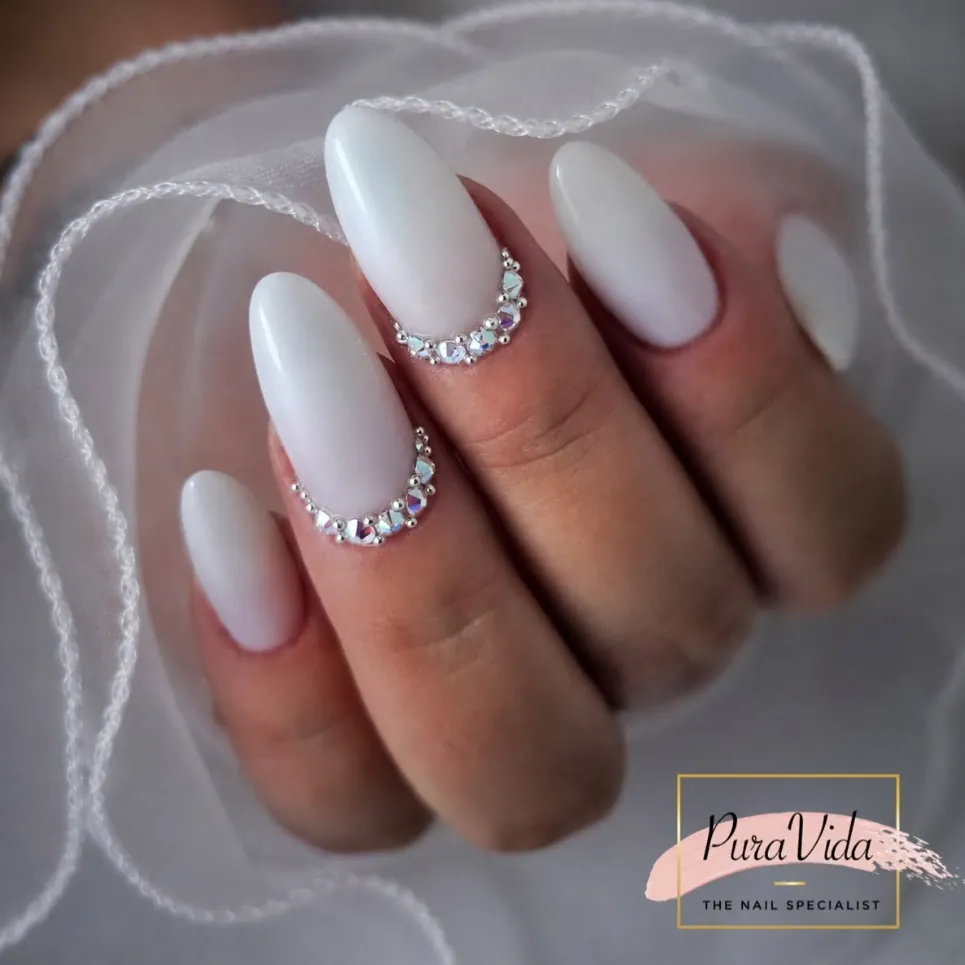 Melkwitte amandelnagels met een rand van steentjes, in wit organza